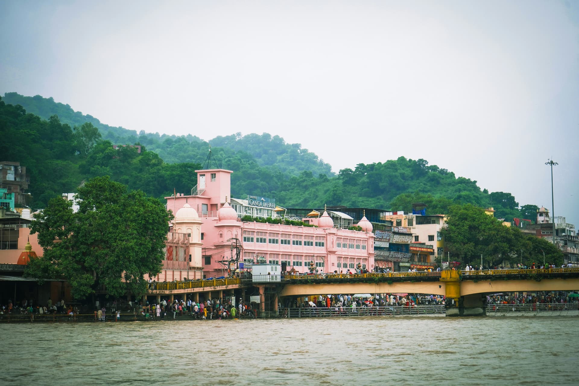 Clean and simple dharamshala room with basic furniture near the Ganga in Haridwar
