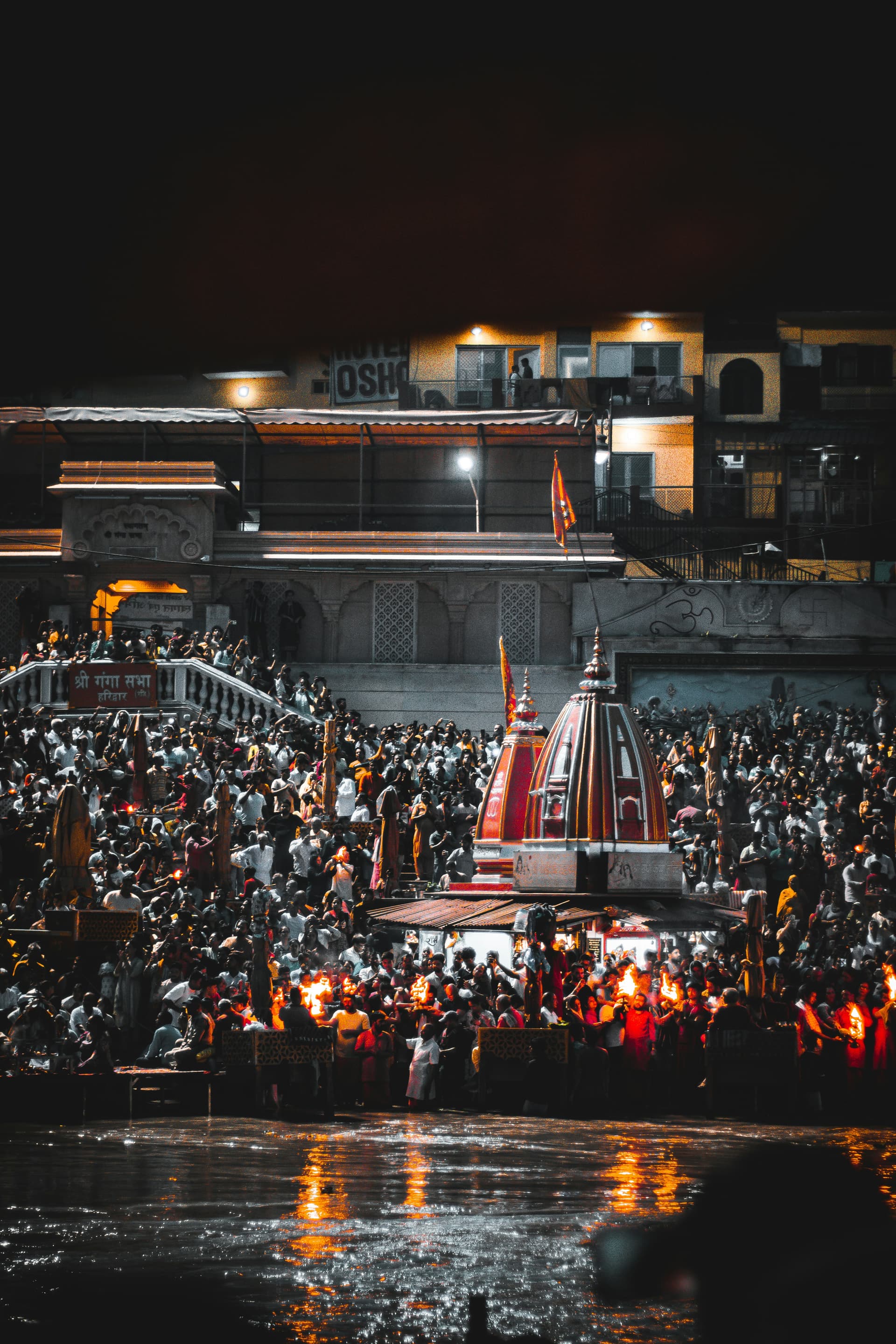 Priests performing Ganga Aarti at Har Ki Pauri in Haridwar with fire lamps and flowers